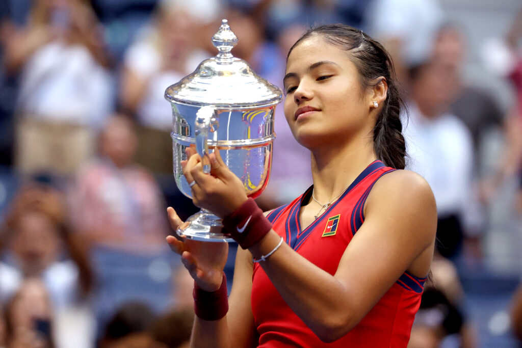 Emma Raducanu looking at the US Open trophy after beating Leylah Fernandez in the 2021 final.