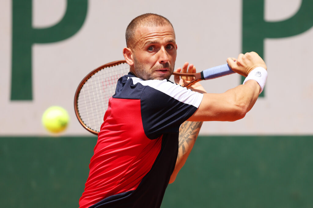 Daniel Evans of Great Britain plays a backhand against Thanasi Kokkinakis of Australia during their Men's Singles First Round Match on Day One of the 2023 French Open at Roland Garros on May 28, 2023 in Paris, France.