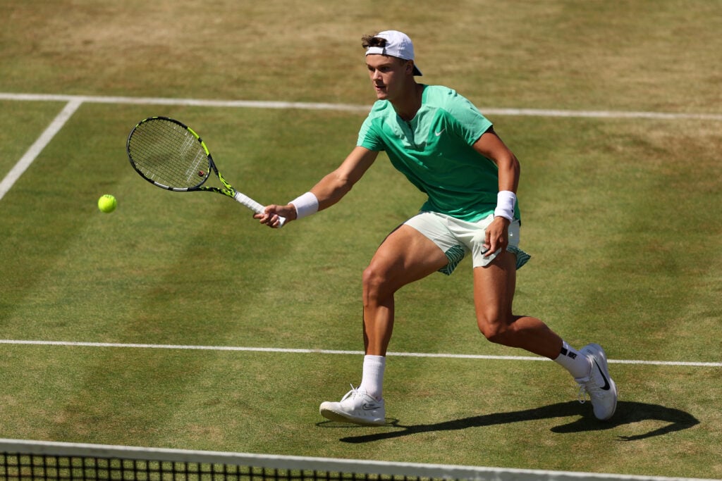 Holger Rune of Denmark plays a forehand against Lorenzo Musetti of Italy during the Men's Singles Quarter Final match on Day Five of the cinch Championships at The Queen's Club on June 23, 2023 in London, England.