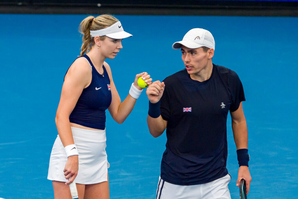 Katie Boulter (L) and Charles Broom of Great Britain talk tactics in their Group F doubles match against Maria Lourdes Carle and Tomas Martin Etcheverry of Argentina during day four of the 2025 United Cup at Ken Rosewall Arena on December 30, 2024 in Sydney, Australia.