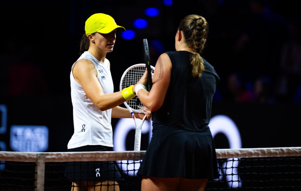 Iga Swiatek of Poland and Jelena Ostapenko of Latvia shake hands at the net after the quarter-final on Day 5 of the Porsche Tennis Grand Prix at Porsche Arena on April 19, 2025 in Stuttgart, Germany