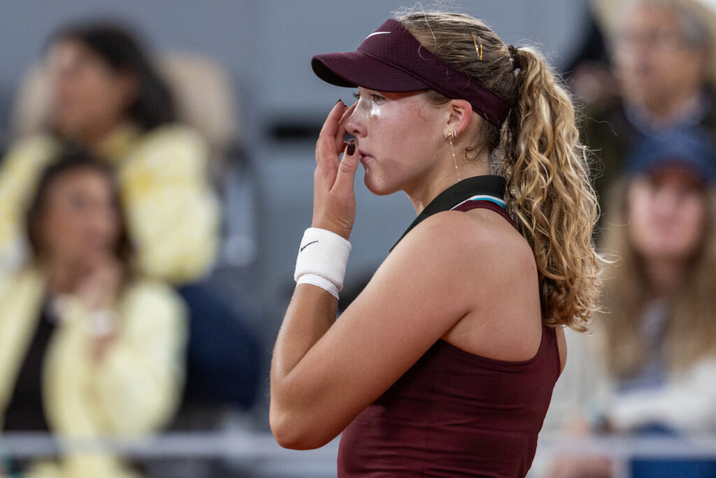Mirra Andreeva wipes away tears during her defeat to Lois Boisson at Roland Garros