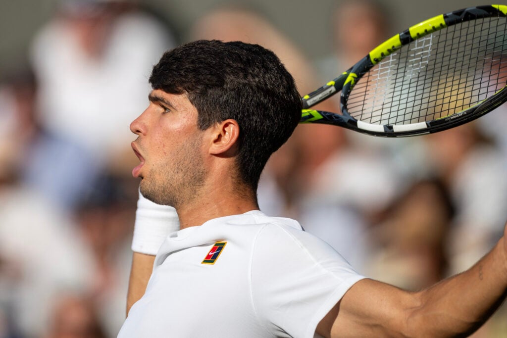 Carlos Alcaraz hits a shot during the 2026 Wimbledon final.