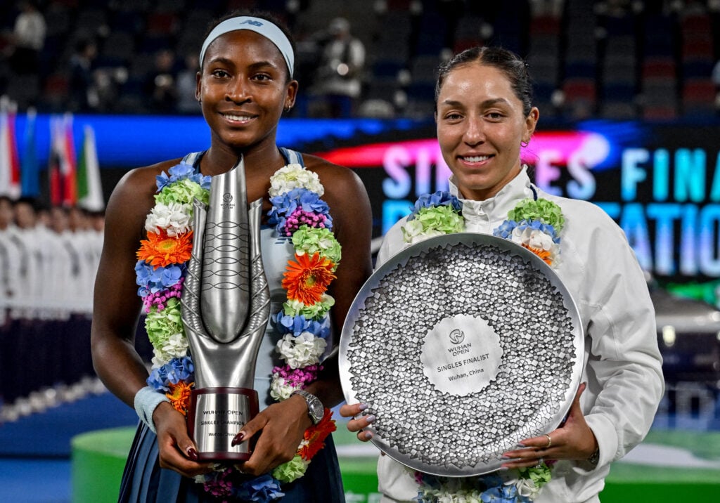 Winner USA's Coco Gauff (L) and runner-up USA's Jessica Pegula (R) pose with their trophies during an award ceremony for their women's singles at the Wuhan Open tennis tournament in Wuhan, Central China's Hubei province on October 12, 2025.