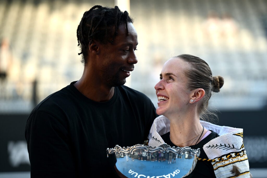 Gael Monfils and Elina Svitolina look at one another whilst holding a trophy