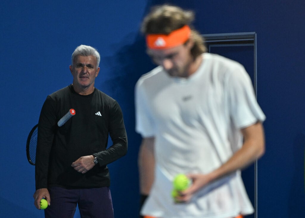 Apostolos Tsitsipas watching Stefanos Tsitsipas practicing at the 2026 Qatar Open.