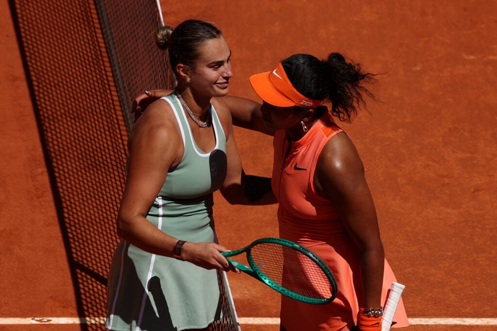 Aryna Sabalenka (L) of Belarus celebrates winning match point and embraces Naomi Osaka of Japan after their match on Day 8 of the Mutua Madrid Open at La Caja Magica on April 27, 2026 in Madrid, Spain.