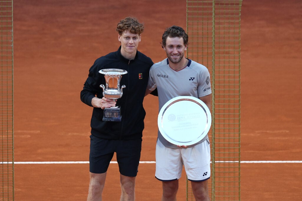 Jannik Sinner and Casper Ruud pose with their respective trophies after the 2026 Italian Open final.