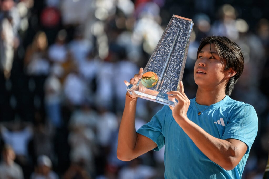 Learner Tien poses with the 2026 Geneva Open trophy.