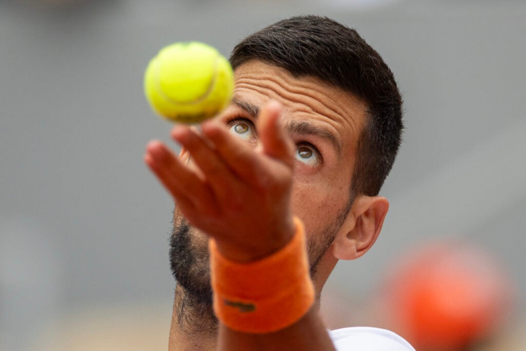 Novak Djokovic practices his serve ahead of the French Open