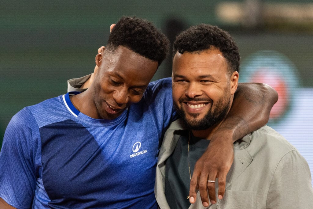Gael Monfils hugs Jo-Wilfried Tsonga during a ceremony honoring Tsonga's career on day 2 of the French Open tennis tournament on Court Philippe-Chatrier at the Roland-Garros Complex in Paris, France.