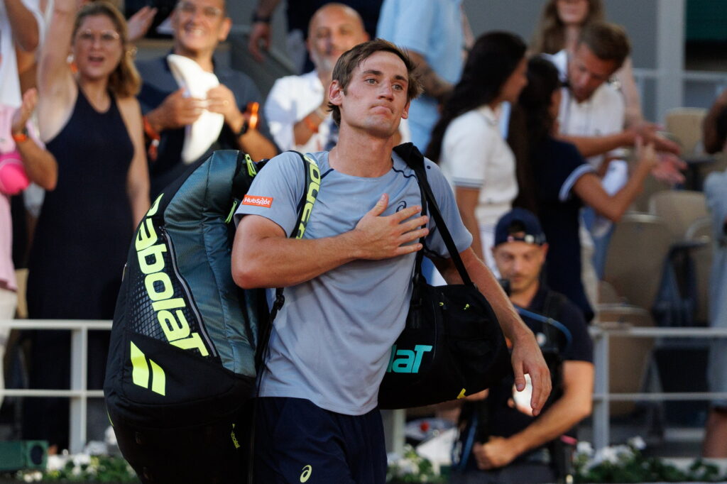 Valentin Royer leaving the court after losing to Novak Djokovic after their match at Roland Garros in 2026.