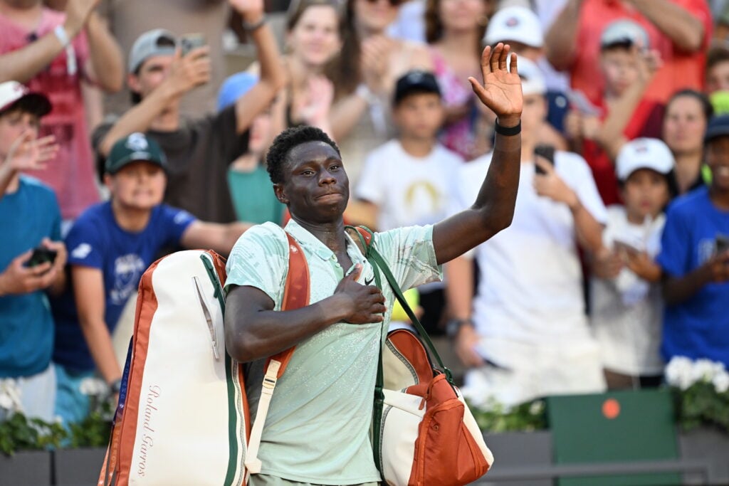 Moise Kouame leaves the court after losing to Alejandro Tabilo at Roland Garros in 2026.
