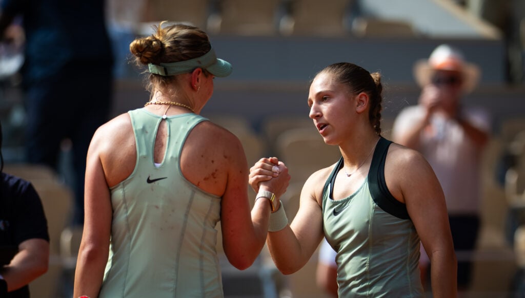 Diane Parry shakes Amanda Anisimova's hand after beating her at Roland Garros in 2026.