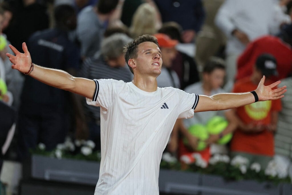 Jakub Mensik celebrates after beating Andrey Rublev at Roland Garros in 2026.