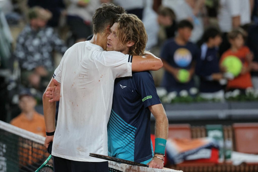 Jakub Mensik hugs Andrey Rublev after beating him at Roland Garros in 2026.