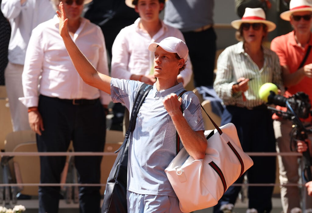 Jannik Sinner leaves the court after losing to Juan Manuel Cerundolo at Roland Garros in 2026.