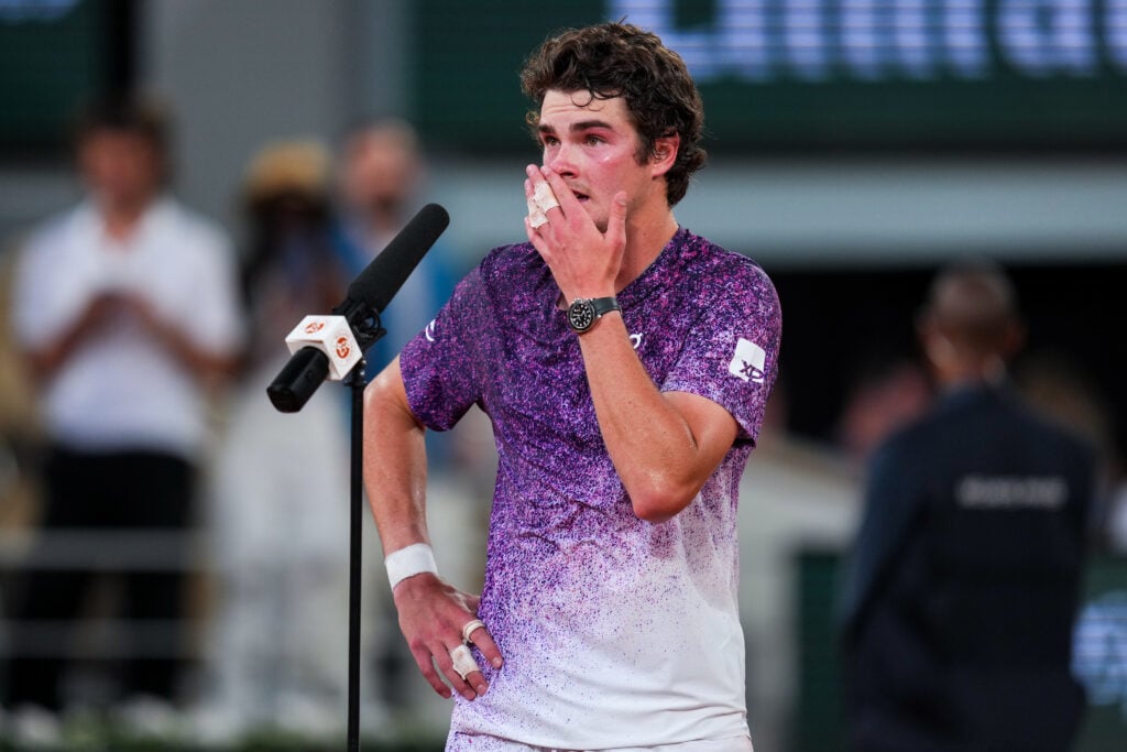 Joao Fonseca addresses the crowd after beating Novak Djokovic at the 2026 French Open.