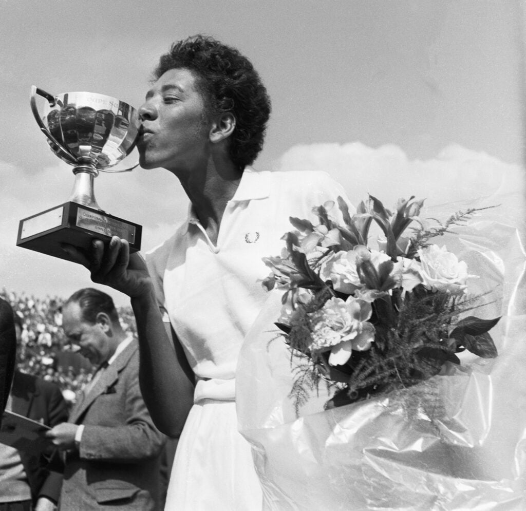 Althea Gibson kissing the Trophy Cup after winning in Paris