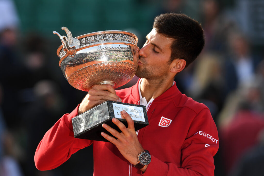 Champion Novak Djokovic of Serbia kisses the trophy following his victory during the Men's Singles final match against Andy Murray of Great Britain on day fifteen of the 2016 French Open at Roland Garros on June 5, 2016 in Paris, France.