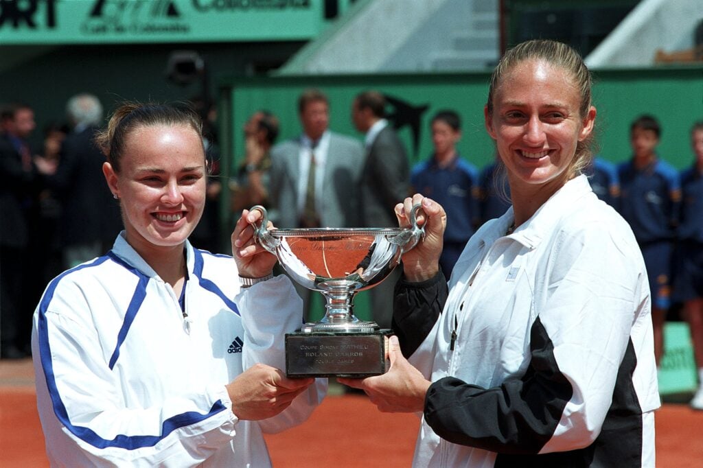 Martina Hingis and Mary Pierce hold the 2000 French Open Women's Doubles trophy