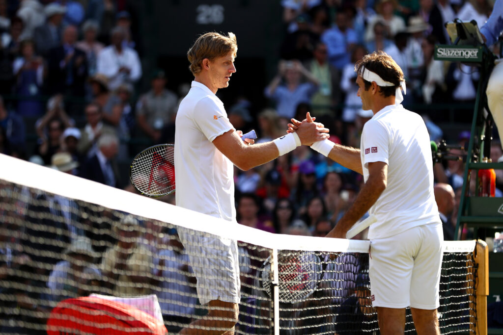 Kevin Anderson of South Africa and Roger Federer of Switzerland embrace at the net following their Men's Singles Quarter-Finals match on day nine of the Wimbledon Lawn Tennis Championships at All England Lawn Tennis and Croquet Club on July 11, 2018 in London, England. Anderson won the match 6-2, 7-6, 5-7, 4-6, 11-13 in 4hr 13min.