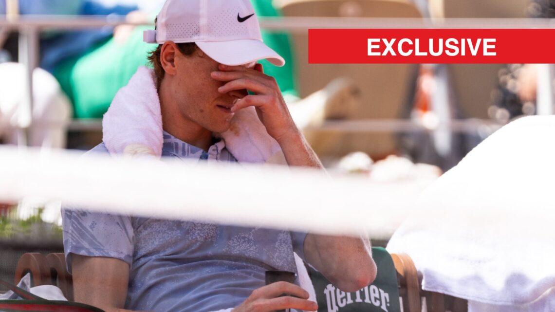 Jannik Sinner covers his face at Roland Garros