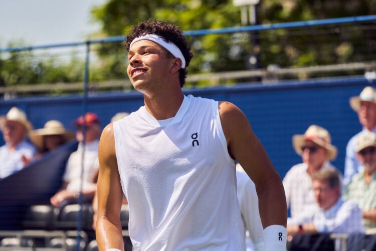Ben Shelton smiles while playing Casper Ruud at the Giorgio Armani Tennis Classic
