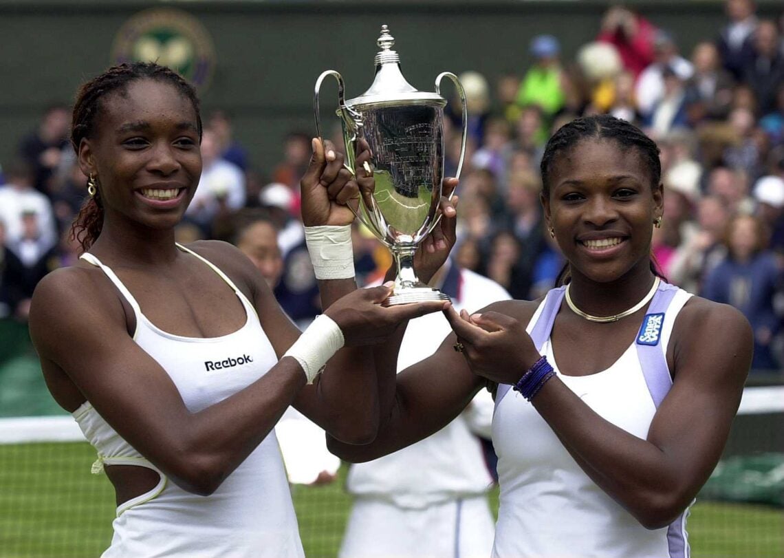 10 Jul 2000: Venus and Serena Williams of the USA lift the winners trophy after the final of the womens doubles in the Wimbledon Lawn Tennis Champ...