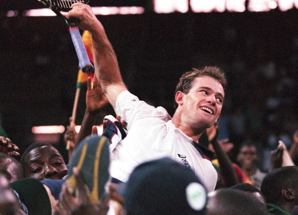 Zimbabwe's Byron Black is carried by fans after beating Chile's Marcelo Rios in the reverse singles of the Davis Cup Tie 26 September 1999. Black won 7-6 (7-3), 3-6, 6-2, 7-6 (8/6) to help Zimbabwe win the tie 4-1 at the City Sports Centre in Harare.