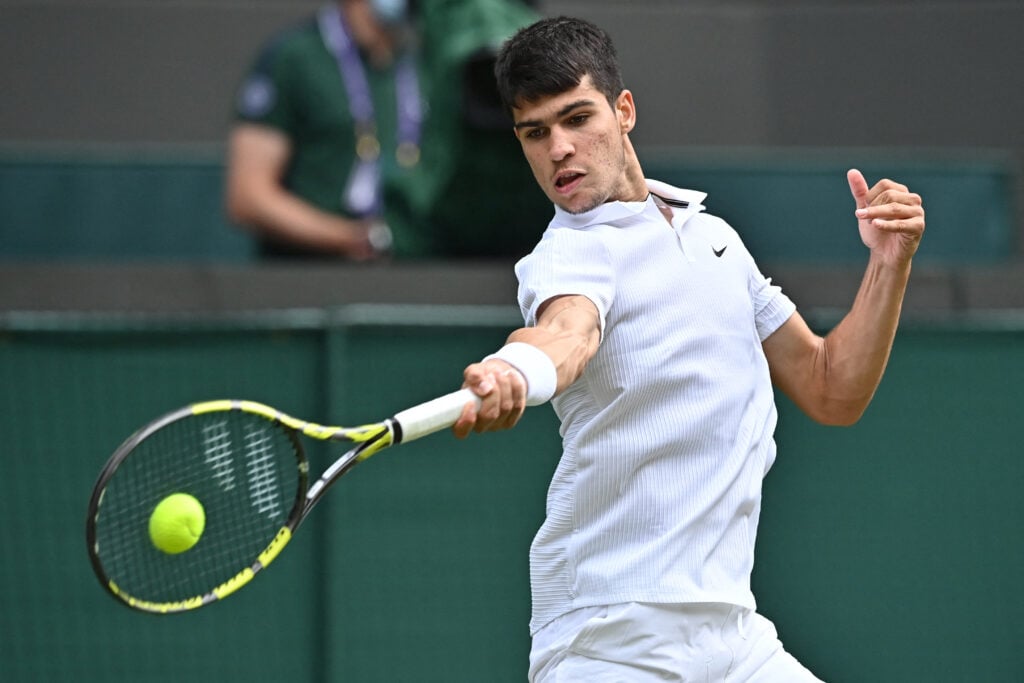 Spain's Carlos Alcaraz returns to Russia's Daniil Medvedev during their men's singles second round match on the fourth day of the 2021 Wimbledon Championships at The All England Tennis Club in Wimbledon, southwest London, on July 1, 2021.