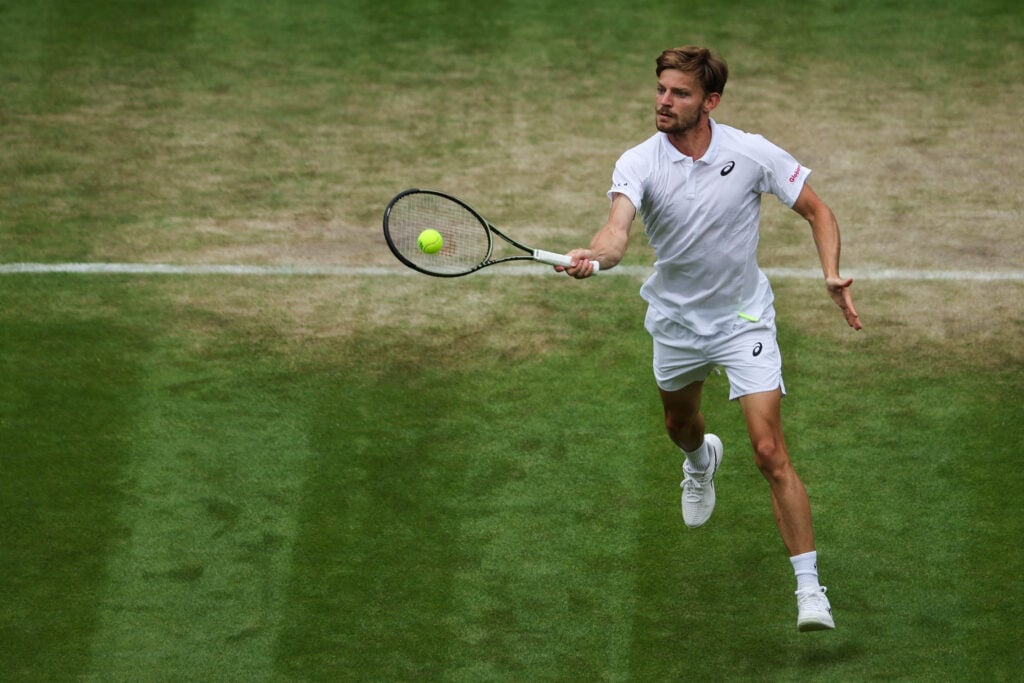 Belgium's David Goffin returns the ball to Britain's Cameron Norrie during their men's singles quarter final tennis match on the ninth day of the 2022 Wimbledon Championships at The All England Tennis Club in Wimbledon, southwest London, on July 5, 2022.
