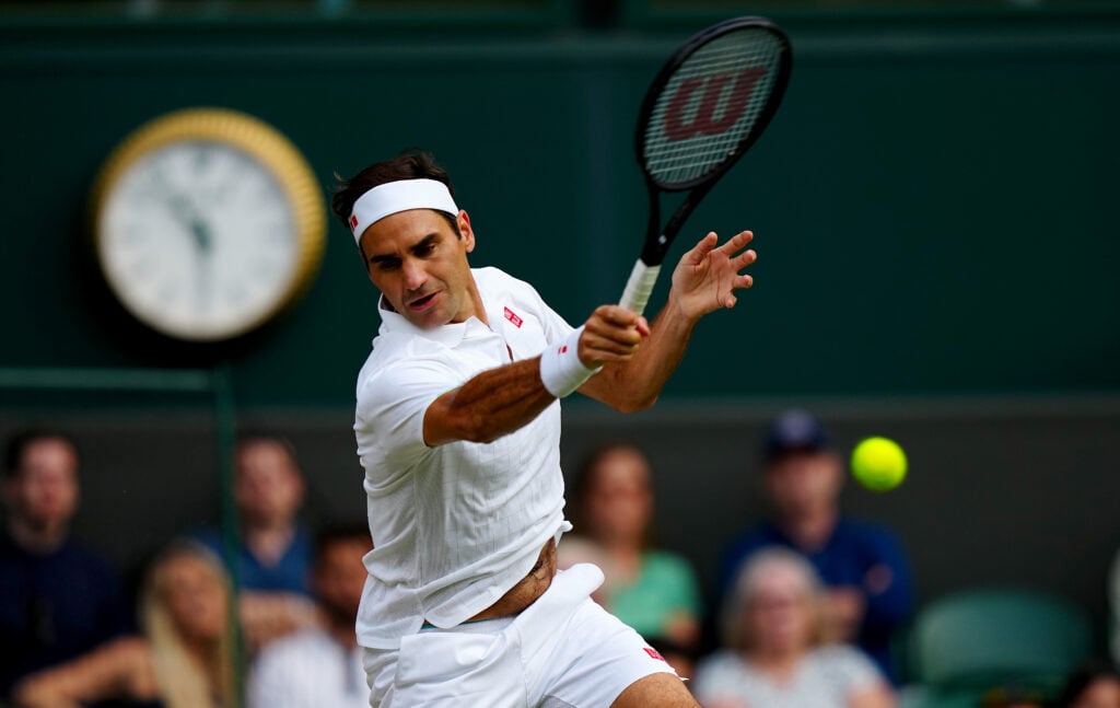 Roger Federer hits a forehand at Wimbledon in 2021.