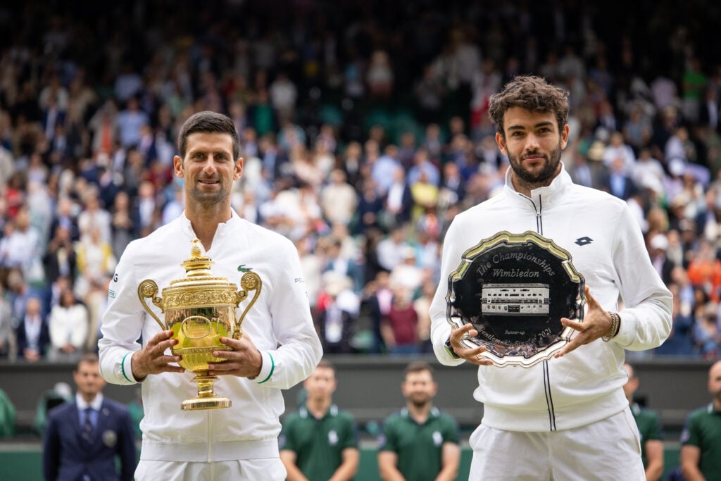 Novak Djokovic of Serbia and Matteo Berrettini of Italy stand together after receiving there trophies at The Wimbledon Lawn Tennis Championship at the All England Lawn and Tennis Club at Wimbledon on July 11, 2021 in London, England.
