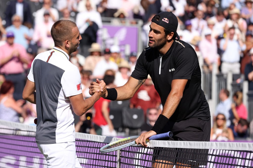 Matteo Berrettini of Italy (R) interacts with Daniel Evans of Great Britain after winning their Men's Singles First Round match on day two of the cinch Championships at The Queen's Club on June 14, 2022 in London, England.