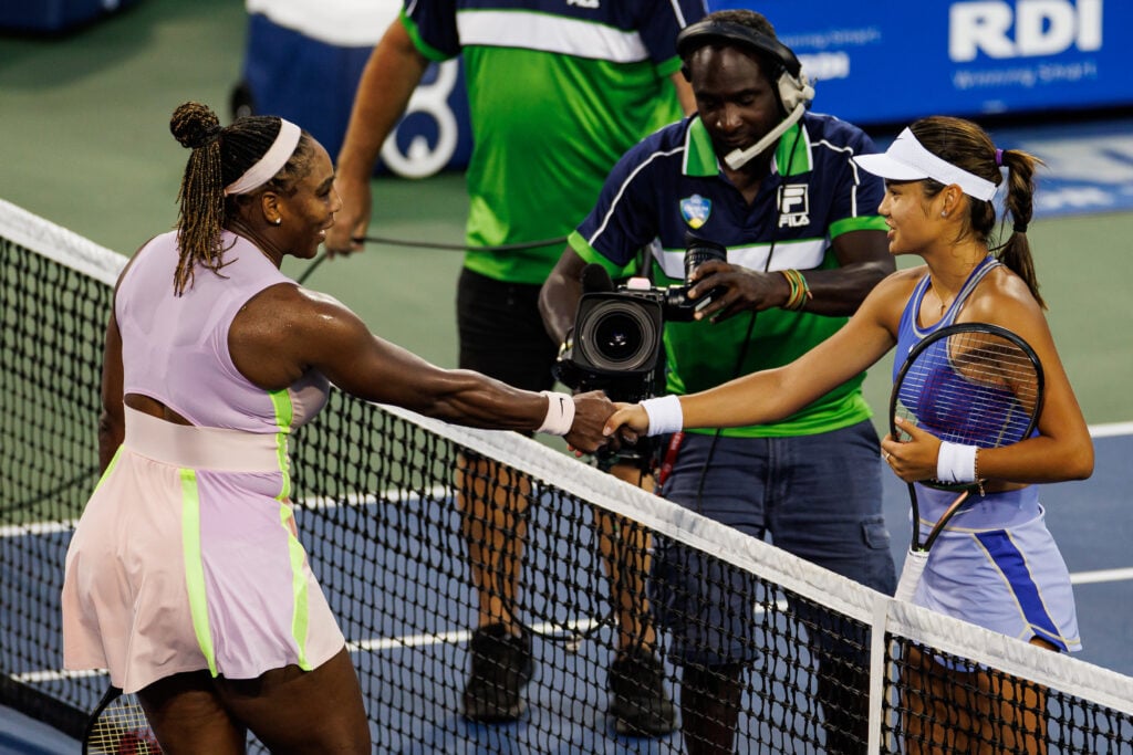 Emma Raducanu of Great Britain shakes hands with Serena Williams of the United States after beating herin the first round of the women's singles at the Lindner Family Tennis Center on August 16, 2022 in Mason, Ohio.