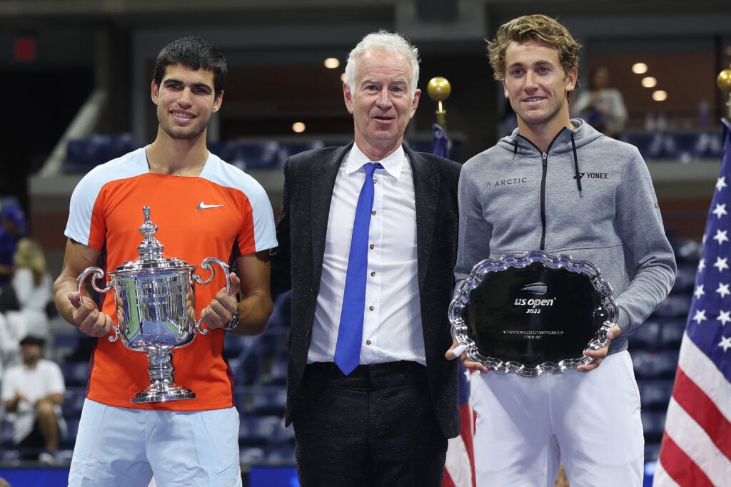 Carlos Alcaraz of Spain, John McEnroe and Casper Ruud of Norway pose with their trophies after their Men’s Singles Final match on Day Fourteen of the 2022 US Open at USTA Billie Jean King National Tennis Center on September 11, 2022 in the Flushing neighborhood of the Queens borough of New York City.