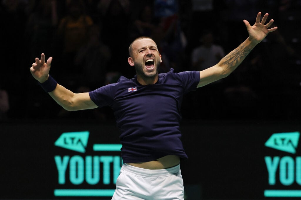 Dan Evans celebrates as Great Britain win the Davis Cup.