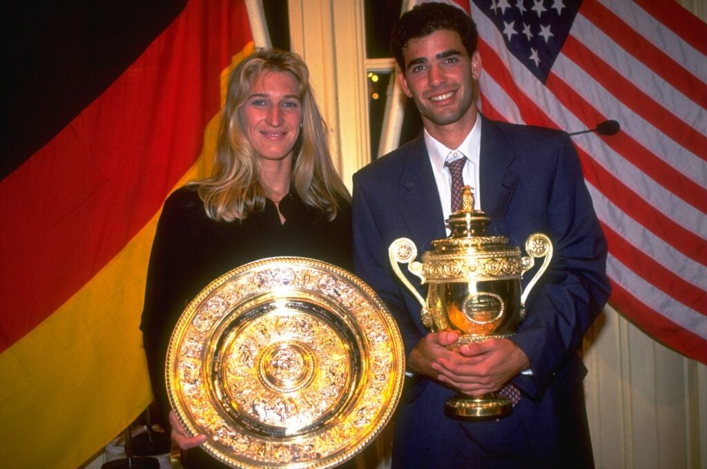 Steffi Graf of Germany and Pete Sampras of the USA hold their respective trophies during the Champions'' dinner after their victory in the Lawn Tennis Championships at Wimbledon in London.