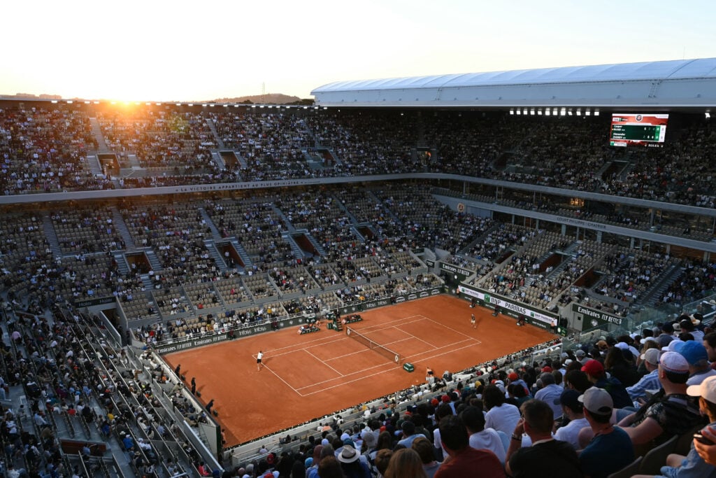 Spectators watch Norway's Casper Ruud and Germany's Alexander Zverev play their men's singles semi final match at sunset on Court Philippe-Chatrier on day thirteen of the French Open tennis tournament at the Roland Garros Complex in Paris on June 7, 2024.