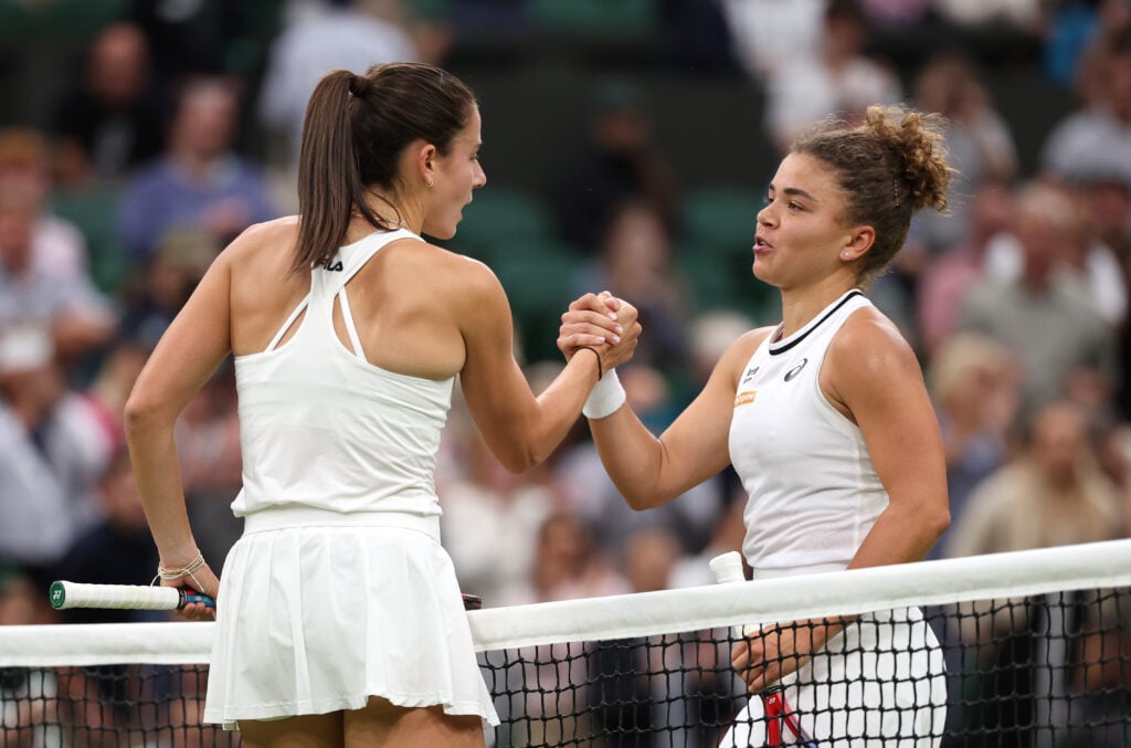Jasmine Paolini of Italy (R) meets Emma Navarro of United States at the net following victory in the Ladies' Singles Quarter Final match during day nine of The Championships Wimbledon 2024 at All England Lawn Tennis and Croquet Club on July 09, 2024 in London, England.