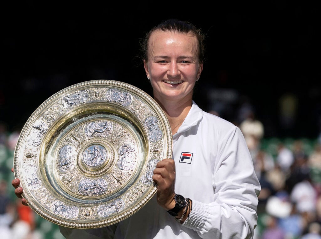 Barbora Krejcikova poses with the Wimbledon trophy after winning the 2024 title.