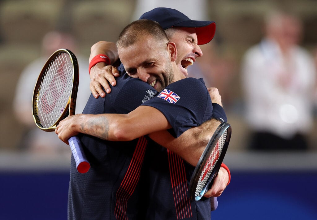 Dan Evans of Team Great Britain celebrates with partner Andy Murray of Team Great Britain after winning match point against Sander Gille of Team Belgium and Joran Vliegen of Team Belgium during the Men's Doubles second round match on day four of the Olympic Games Paris 2024 at Roland Garros on July 30, 2024 in Paris, France.