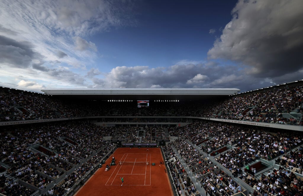 A graduated grey filter was used for this image.) A general view of Court Philippe-Chatrier as Jannik Sinner of Italy serves to Novak Djokovic of Serbia during the Men's Singles Semi Final match on Day Thirteen of the 2025 French Open at Roland Garros on June 06, 2025 in Paris, France.