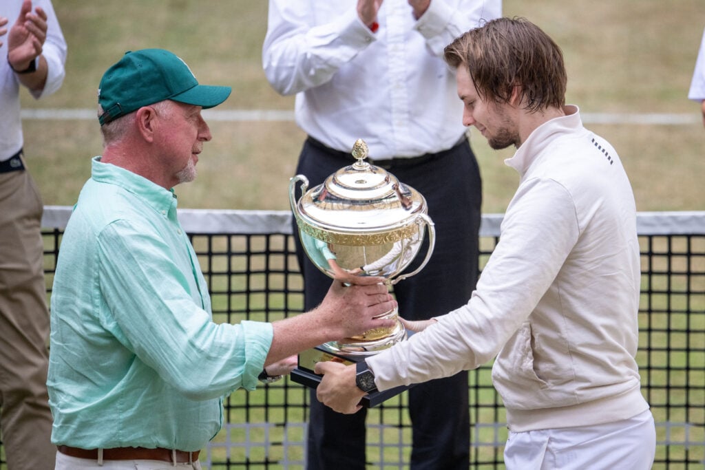 Boris Becker hands Alexander Bublik the Halle Open trophy in 2025.
