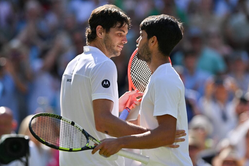 Taylor Fritz and Carlos Alcaraz embrace after their semi-final at Wimbledon in 2025.