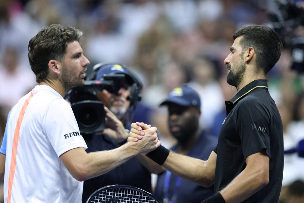 Serbia's Novak Djokovic (R) shakes hands with celebrates Britain's Cameron Norrie after winning their men's singles third round match on day six of the US Open tennis tournament at the USTA Billie Jean King National Tennis Center in New York City on August 29, 2025.