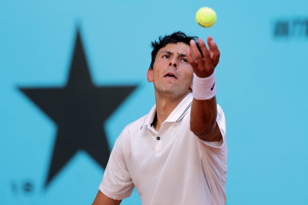 US Emilio Nava tosses the ball into the air to serve against France's Arthur Fils during their 2026 ATP Tour Madrid Open tennis tournament third round singles match at the Caja Magica in Madrid, on April 26, 2026.