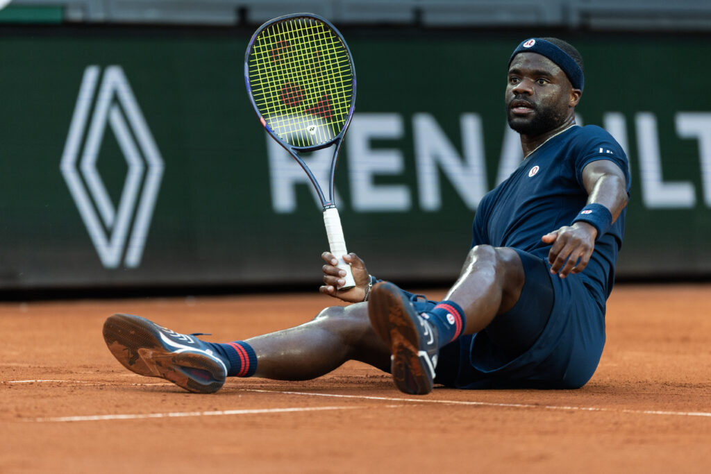 Frances Tiafoe on the floor during his fourth-round match at the 2026 French Open.
