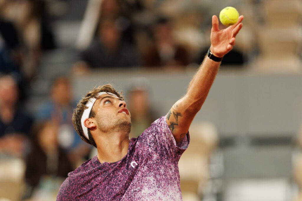 Flavio Cobolli prepares to serve during his quarter-final win over Felix Auger-Aliassime.